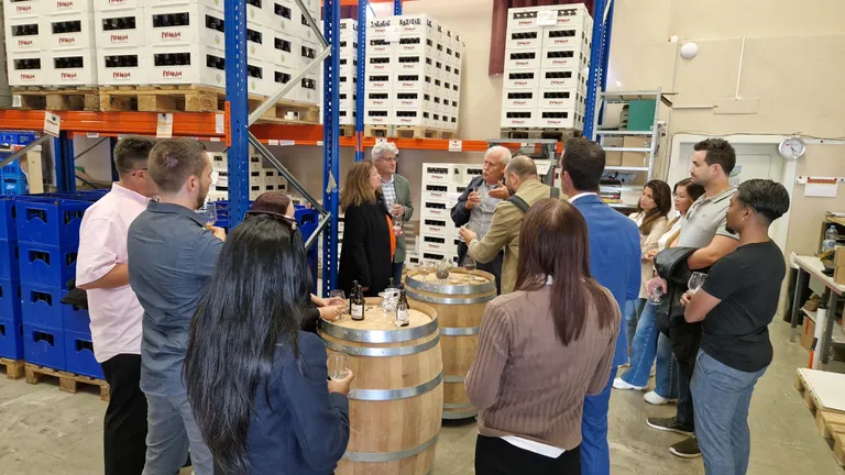 The Bosshard & Partner team stands in the beer cellar and listens to what the beer master has to say.